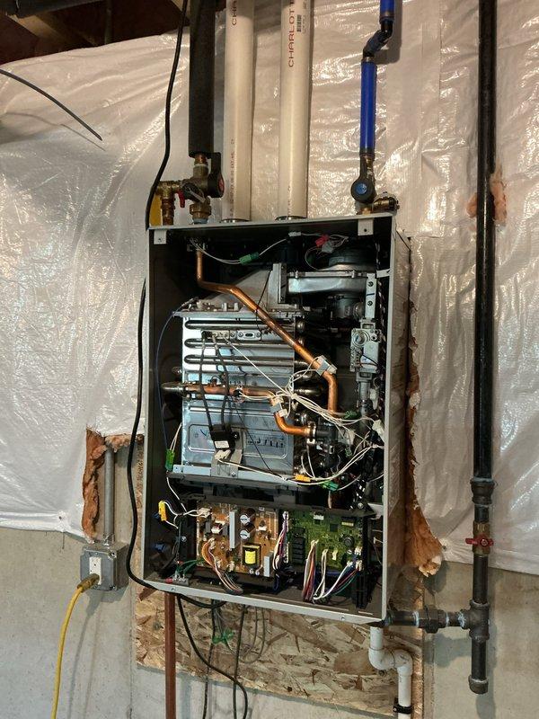 Responded to service call for Noritz tankless water heater displaying error code 11, indicating no ignition. Performed diagnostic inspection of unit by removing front access panel to examine internal components, control board, ignition system, and gas supply connections. Inspected and removed inlet water filter screen, which showed significant accumulation of sediment and debris causing restricted water flow. Cleaned filter assembly and verified proper water pressure and flow rate to unit. Checked exhaust and intake PVC venting system for proper installation and clearance. Examined flame sensor, igniter assembly, and gas valve operation. Error code 11 typically indicates ignition failure due to insufficient water flow, gas supply issues, or faulty ignition components. Filter blockage was identified as primary cause of flow restriction triggering the error code. Reinstalled cleaned filter and tested unit operation to confirm proper ignition sequence and hot water delivery.