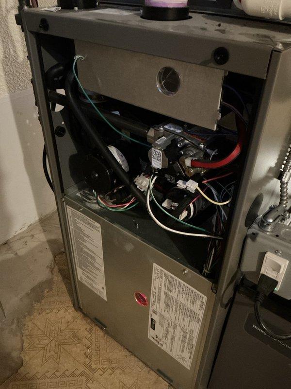 Completed comprehensive Gold-level preventative maintenance and tune-up on Lennox WT 10-2030 furnace system. Performed full system inspection with front access panel removal to evaluate internal components including blower motor assembly, electrical connections, and control boards. Conducted diagnostic testing of all mechanical and electrical systems, verified proper operation of blower motor and fan housing, and inspected wiring harness connections throughout unit. Measured and recorded temperature differential across heat exchanger, confirming system operating within manufacturer specifications at 02:44 reading. Examined furnace burner assembly, heat exchanger integrity, and combustion components for proper function and safety compliance. Verified gas pressure, inspected flue piping and PVC condensate drainage system for proper installation and flow. All safety controls, limit switches, and flame sensors tested and confirmed operational. System found to be in excellent condition cons