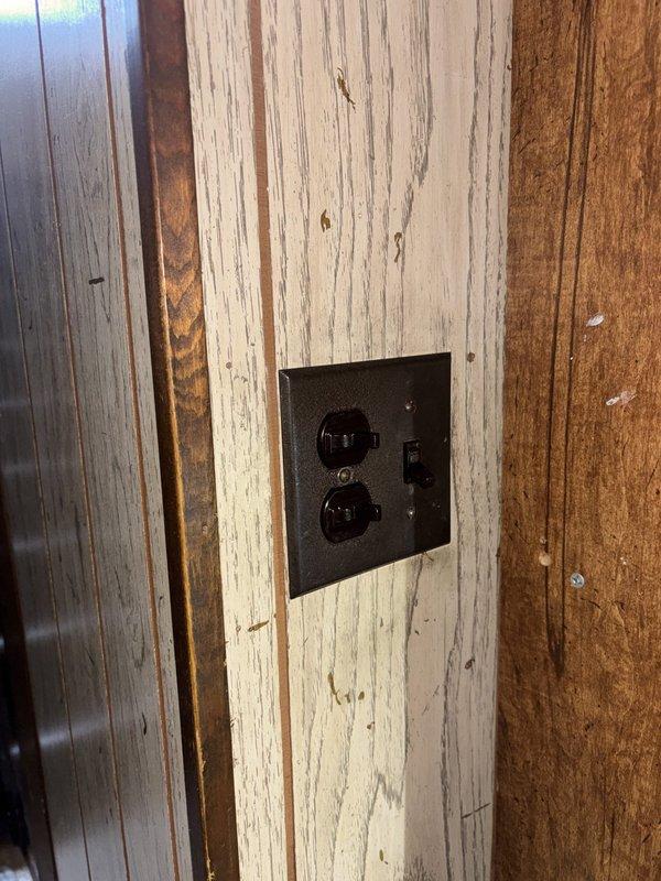 Responded to service call for non-functioning outlets in kitchen and basement areas. Upon inspection, identified tripped GFCI outlet on wood-paneled wall requiring reset. Tested and verified proper operation of affected circuits. Inspected low-voltage transformer installation in attic space to ensure proper wiring connections and functionality. All outlets restored to normal operation and circuits tested for proper grounding and voltage.