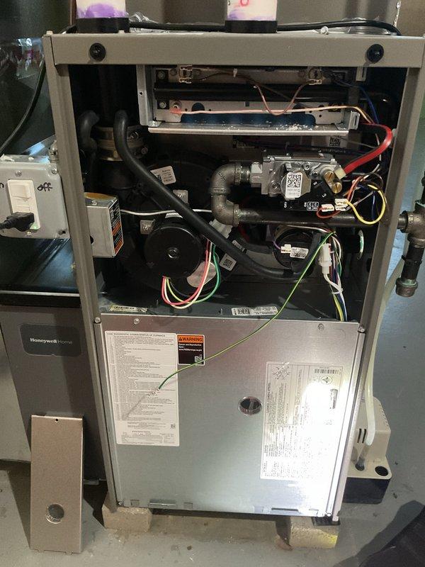Completed comprehensive Gold-level preventive maintenance inspection on 1-year-old Lennox furnace located in basement. Performed full system tune-up including inspection of heat exchanger, burner assembly, gas valve, and blower motor components. Verified all electrical connections, tested ignition system, checked gas pressure and combustion efficiency, inspected and cleaned burner assembly, examined flue piping and venting system for proper operation. Evaluated air filter condition and airflow, tested thermostat operation and system cycling, and confirmed all safety controls functioning properly. Documented internal components with photographs showing clean burner compartment, properly connected gas piping with visible manufacturer labels and QR identification tags, and well-maintained blower assembly. Unit operating within manufacturer specifications with no deficiencies noted. All components found in excellent condition consistent with age of equipment. System tested and left in prop