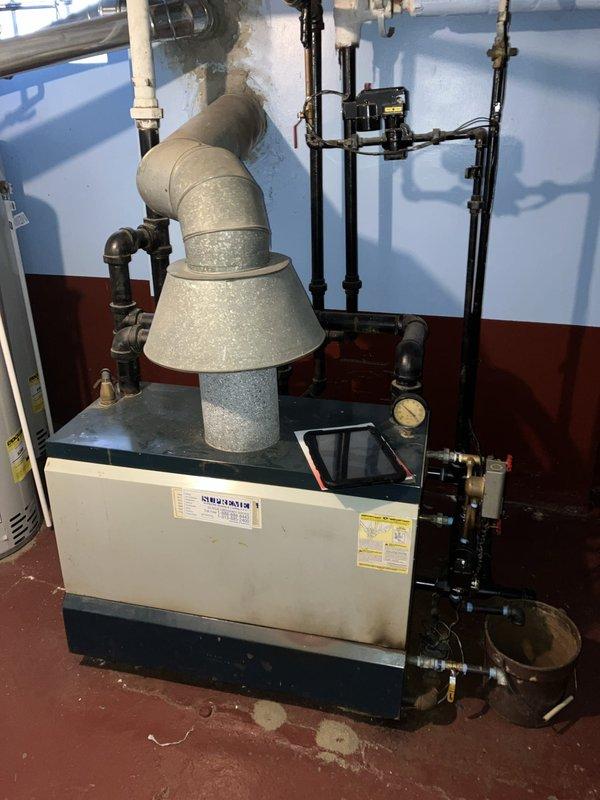 Completed comprehensive inspection and estimate on approximately 50-year-old steam boiler system located in basement. Evaluated boiler unit condition, venting system including exhaust piping and flue configuration, pressure gauges, brass valves, and associated piping infrastructure. Assessed electrical panel supplying power to heating system and documented current operational status of all components. System currently operational; provided recommendations and estimate for equipment replacement or necessary repairs based on age and condition of existing steam boiler installation.
