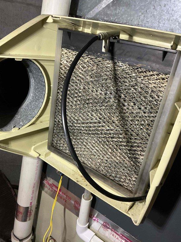 Completed comprehensive Gold-level furnace inspection on dual HVAC systems in basement location, including 3-year-old and 25-year-old units. Performed thorough examination of Daikin furnace system, ductwork, air handler components, and condensate drain lines. Documented heavily soiled air filter requiring replacement due to significant dust and debris accumulation, inspected metal mesh framework and filter housing integrity, verified all ductwork connections and PVC piping systems operational, and confirmed both units functioning properly at time of inspection.