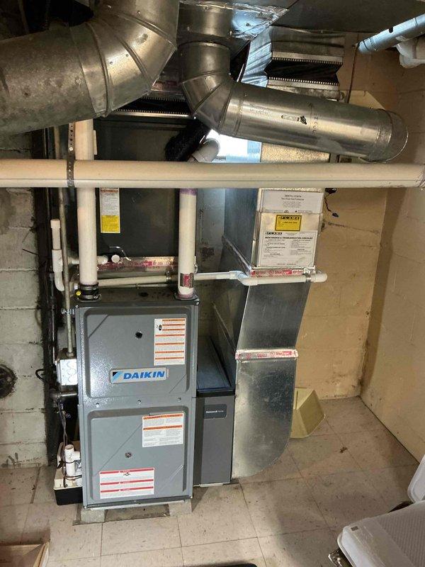 Completed comprehensive Gold-level furnace inspection on dual HVAC systems in basement location, including 3-year-old and 25-year-old units. Performed thorough examination of Daikin furnace system, ductwork, air handler components, and condensate drain lines. Documented heavily soiled air filter requiring replacement due to significant dust and debris accumulation, inspected metal mesh framework and filter housing integrity, verified all ductwork connections and PVC piping systems operational, and confirmed both units functioning properly at time of inspection.