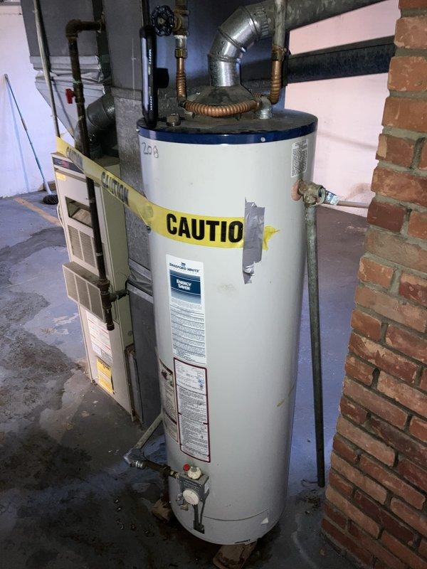 Completed free estimate for replacement of 25-year-old furnace located in basement and 25-year-old central air conditioning unit located outside. Photographed existing equipment including basement furnace with adjacent water heater and outdoor condenser unit with heavily rusted fan guard and weathered copper refrigerant lines. Customer also requested separate estimate for water heater replacement to be scheduled as plumbing service at later date.