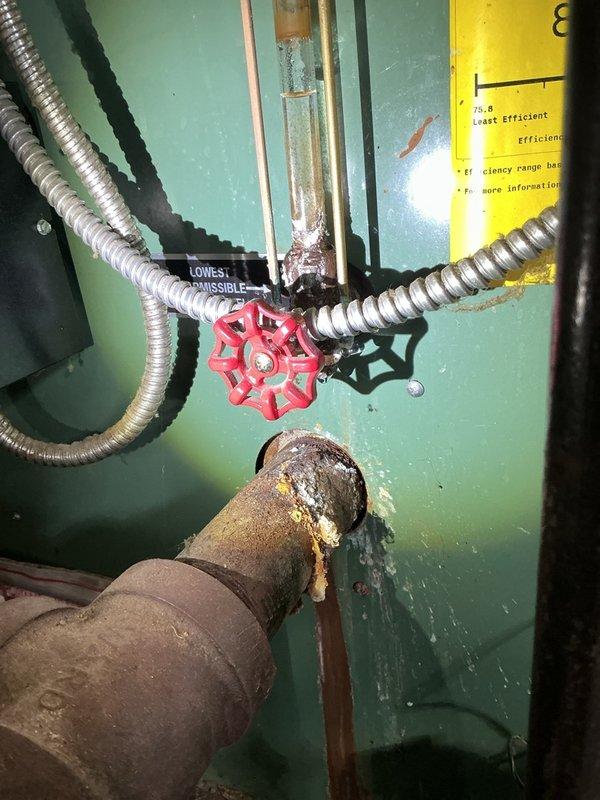 Completed comprehensive Gold Boiler Inspection on an 8-year-old steam boiler system located in basement. Performed thorough visual assessment of all accessible components including piping infrastructure, connections, and mechanical systems. Inspection revealed extensive corrosion present on copper and galvanized piping throughout the distribution system, with significant oxidation, rust buildup, and green discoloration at multiple pipe joints and fittings. Documented heavily corroded pipe connections with flaking surfaces and deteriorated insulation on aged piping sections. Evaluated system valving including gate valves and shutoff controls. Equipment currently operational at time of inspection. Captured photographic documentation of corroded piping conditions and mechanical components for maintenance records and future reference.
