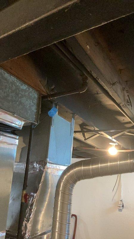 Responded to gas leak service call at rental property where utility company had previously identified and flagged potential leak points in connected piping. Conducted thorough inspection of basement mechanical area, examining gas piping connections, HVAC equipment interfaces, and associated utility lines in unfinished space with exposed ceiling joists and ductwork. Documented conditions with photographic evidence showing pipe routing, wall-mounted cable runs, and mechanical room components including metal ductwork and flexible duct installations for property owner review and verification of flagged locations.