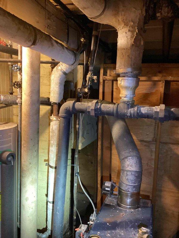 Responded to basement location for steam boiler estimate following reports from plumbing contractor regarding multiple issues and leaking conditions. Performed comprehensive visual inspection of existing steam boiler system, noting advanced age of equipment with significant deterioration of pipe insulation materials, visible corrosion on copper piping components, rust accumulation on various fittings, and evidence of water pooling in drip pan indicating active leakage. Documented condition of all associated piping, valves, and connections throughout the system. Provided detailed estimate for boiler replacement options and necessary remedial work.