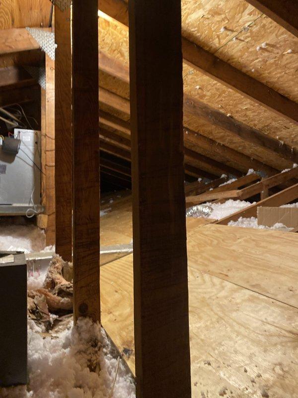 Completed HVAC installation warranty inspection addressing code violations in attic space. Installed working light with on/off switch at attic entrance per code requirements. Constructed 24-inch wide catwalk providing safe access pathway to equipment and established 30-inch wide level service space around air handler unit to meet inspection standards. Created proper attic access opening where none previously existed to allow for future maintenance and code compliance inspections. Verified all HVAC equipment accessible with adequate clearances, proper insulation placement around ductwork, and structural support systems in place. Documentation photos captured showing compliant installation of access infrastructure, catwalk construction, service clearances, and overall attic workspace meeting municipal building code requirements.