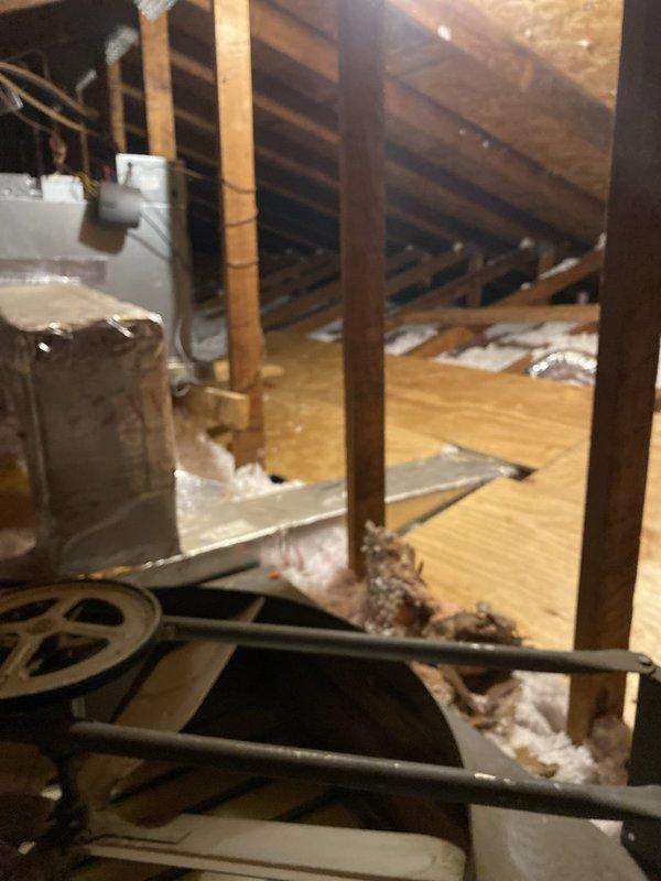 Completed HVAC installation warranty inspection addressing code violations in attic space. Installed working light with on/off switch at attic entrance per code requirements. Constructed 24-inch wide catwalk providing safe access pathway to equipment and established 30-inch wide level service space around air handler unit to meet inspection standards. Created proper attic access opening where none previously existed to allow for future maintenance and code compliance inspections. Verified all HVAC equipment accessible with adequate clearances, proper insulation placement around ductwork, and structural support systems in place. Documentation photos captured showing compliant installation of access infrastructure, catwalk construction, service clearances, and overall attic workspace meeting municipal building code requirements.