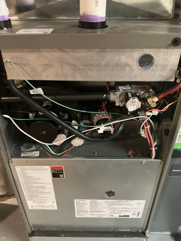 Completed comprehensive Gold-level preventive maintenance inspection on two forced-air furnace units in a residential property—one located in the basement and one on the second floor. Both units are approximately two years old and were operational at time of service. Performed thorough multi-point inspection including examination of all internal components, electrical connections, gas line fittings, control assemblies, and safety devices. Verified proper wiring configurations with color-coded connections to control boards and valve assemblies intact and secure. Inspected burner compartments, heat exchangers, and ventilation systems for proper operation and safety compliance. Documented equipment condition with detailed photographic evidence showing internal components, manufacturer specification labels, and warning decals. All mechanical and electrical systems found to be functioning within normal parameters with no immediate service needs identified.