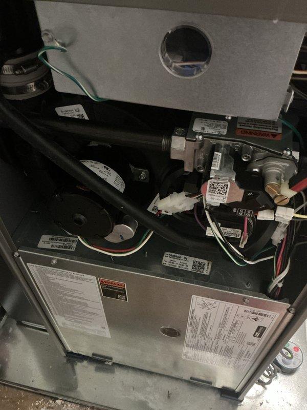 Completed comprehensive Gold-level preventive maintenance inspection on two forced-air furnace units in a residential property—one located in the basement and one on the second floor. Both units are approximately two years old and were operational at time of service. Performed thorough multi-point inspection including examination of all internal components, electrical connections, gas line fittings, control assemblies, and safety devices. Verified proper wiring configurations with color-coded connections to control boards and valve assemblies intact and secure. Inspected burner compartments, heat exchangers, and ventilation systems for proper operation and safety compliance. Documented equipment condition with detailed photographic evidence showing internal components, manufacturer specification labels, and warning decals. All mechanical and electrical systems found to be functioning within normal parameters with no immediate service needs identified.