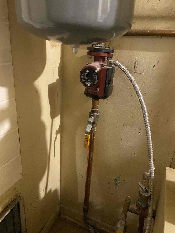 Provided estimate for replacement of 20-year-old hot water boiler system currently located in first floor utility room. Existing unit remains operational but has reached end of expected service life. Assessment included evaluation of current copper piping configuration, circulator pump, expansion tank, zone valves, and integration with existing domestic water heater and HVAC ductwork system to determine optimal replacement specifications and installation requirements.