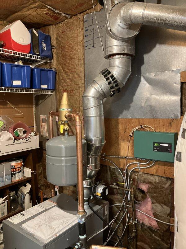 Completed full boiler installation in basement utility area, including mounting and connection of new heating unit with integrated expansion tank and copper piping distribution system. Installed two zone circulator pumps at base of unit for hydronic heating control, along with two thermostats and system controller with proper wiring to green control panel. Established all mechanical and electrical connections per code requirements, utilizing braided flex connectors and rigid copper piping with professional fittings throughout the system. Secured mechanical and electrical permits prior to installation and reconnected all heating zones to ensure proper system operation and zoning capability.