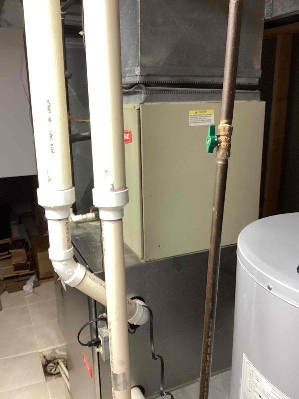 Conducted comprehensive assessment of existing HVAC system in 3-story residential property (18,000 sq ft) to provide Indoor Air Quality enhancement estimate for furnace-based heating system. Evaluated basement mechanical room containing existing furnace unit, ductwork infrastructure, and ventilation components to determine optimal IAQ equipment integration points. Documented current system configuration including metal supply/return ductwork, PVC drainage lines, and cabinet-style furnace unit to develop appropriate humidification and air purification solutions compatible with standard home construction.