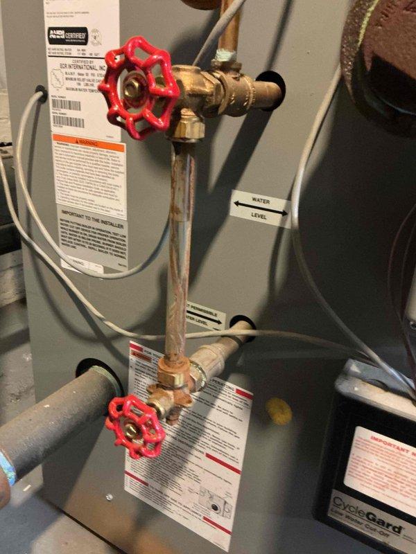 Responded to service call for 2-year-old residential steam boiler in basement with reported sight glass leak causing corrosion. Upon inspection, confirmed active leak at sight glass assembly resulting in moisture accumulation and corrosion on boiler casing and surrounding components. Removed failed sight glass assembly, cleaned mounting surfaces, and installed new sight glass with fresh gaskets and proper torque specifications. Verified all connections were secure and leak-free. Filled boiler to proper water level, pressurized system, and conducted thorough leak test at sight glass and all associated fittings. Confirmed no active leaks present. Inspected surrounding piping, valves, and connections for additional corrosion or moisture damage. Cleaned affected areas and verified system integrity. Cycled boiler through complete operational sequence to ensure proper function. All safety controls tested and operating within manufacturer specifications. Unit covered under parts and labor war