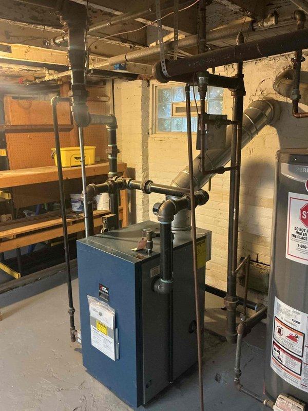 Responded to service call for 2-year-old residential steam boiler in basement with reported sight glass leak causing corrosion. Upon inspection, confirmed active leak at sight glass assembly resulting in moisture accumulation and corrosion on boiler casing and surrounding components. Removed failed sight glass assembly, cleaned mounting surfaces, and installed new sight glass with fresh gaskets and proper torque specifications. Verified all connections were secure and leak-free. Filled boiler to proper water level, pressurized system, and conducted thorough leak test at sight glass and all associated fittings. Confirmed no active leaks present. Inspected surrounding piping, valves, and connections for additional corrosion or moisture damage. Cleaned affected areas and verified system integrity. Cycled boiler through complete operational sequence to ensure proper function. All safety controls tested and operating within manufacturer specifications. Unit covered under parts and labor war