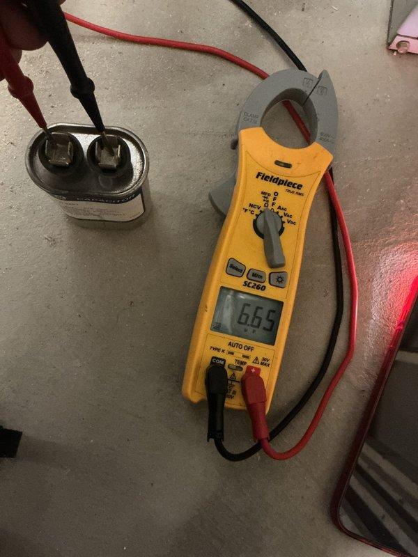 Completed comprehensive furnace tune-up and safety inspection on gas-fired heating unit over 10 years old located in basement. Performed full system diagnostics including electrical testing of blower motor capacitor using clamp meter, verified proper amperage draw at 6.65 amps, and confirmed burner operation with clean blue flame pattern across all burner ports. Inspected gas valve assembly, electrical connections, control board, blower motor assembly, and all safety components. Additionally checked thermostat operation, humidifier function, and hot water tank as part of seasonal maintenance package. All systems operating within normal parameters at time of inspection.