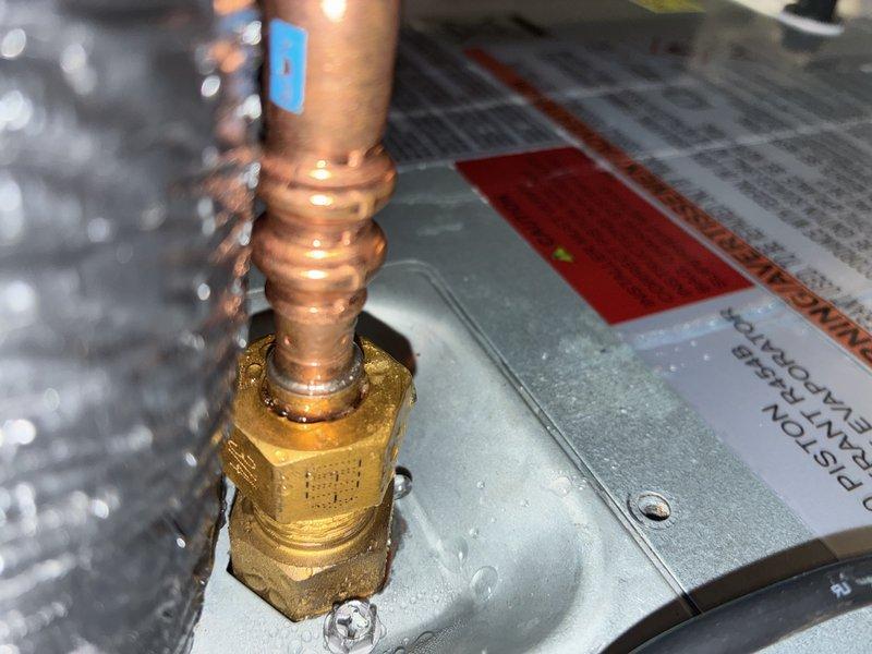 # Warranty Service Completed

Responded to warranty call for no air conditioning to upstairs zone. Upon arrival, performed diagnostic inspection of HVAC system components. Inspected copper refrigerant lines, brass fittings, and connection points for proper installation and potential leaks. Examined valve assemblies and threaded connections on refrigerant piping. Verified proper mounting and secure attachment of all plumbing connections. Documented equipment condition with photographs showing copper tubing with spiral threading, brass connector fittings, and valve assemblies mounted to system housing. All components inspected showed normal operational wear with no visible defects. System connections appeared secure with proper threading engagement at all junction points.