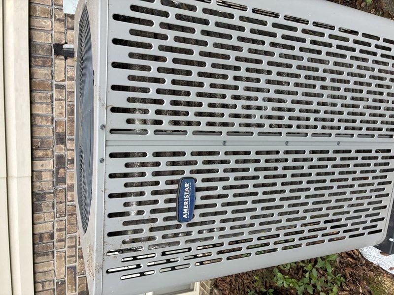 Completed seasonal air conditioning service call on Ameristar outdoor condensing unit. Performed comprehensive system inspection including visual assessment of cabinet condition, fan assembly operation, and overall equipment status. Unit exterior and fan grille showed normal wear consistent with outdoor installation. Documented equipment condition through photographic records of condenser cabinet and top-mounted fan assembly for warranty documentation purposes under active 2-year parts and labor and 12-year parts coverage. All components inspected and found operational at time of service.