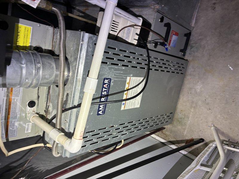 Responded to callback for no air conditioning on Air Star HVAC system. Upon arrival, inspected both indoor furnace/air handler unit and outdoor condensing unit. Indoor unit located in basement mechanical room showed proper electrical connections and condensate drain line installation. Outdoor unit examined and found fan assembly with protective grille intact and operational components accessible. Verified refrigerant lines, electrical connections, and mounting stability on concrete pad. Documented system configuration with photos showing complete installation including blower assembly, control wiring, and ventilation components. All major equipment components visually inspected for proper operation and installation integrity.