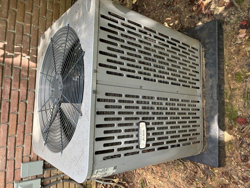Responded to service call for air conditioning unit short cycling and failing to maintain temperature. Upon arrival, inspected outdoor condensing unit and found system experiencing frequent on-off cycling preventing adequate cooling. Examined condenser unit positioned on concrete pad against building exterior, noting operational fan assembly and intact cabinet with proper ventilation louvers. Investigated indoor components including condensate drainage system, observing PVC drain line with visible residue buildup and discoloration inside piping. Documented equipment conditions through photographs for service records. System requires further diagnostic testing to identify root cause of short cycling issue, which may include refrigerant charge verification, electrical component testing, thermostat calibration check, and potential condensate drain line cleaning to restore proper operation.
