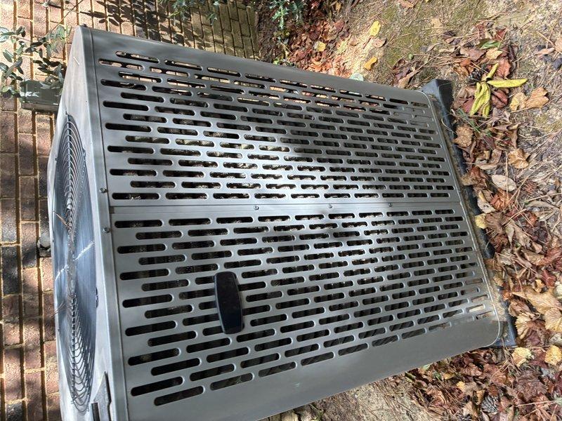 Completed routine Service Agreement maintenance visit on residential air conditioning system. Inspected outdoor condenser unit, documenting equipment condition and operational status. Removed and examined a metallic cylindrical component, likely a filter drier or refrigerant line component, as part of standard system evaluation. Unit appeared to be functioning within normal parameters with no immediate repairs required at time of inspection.