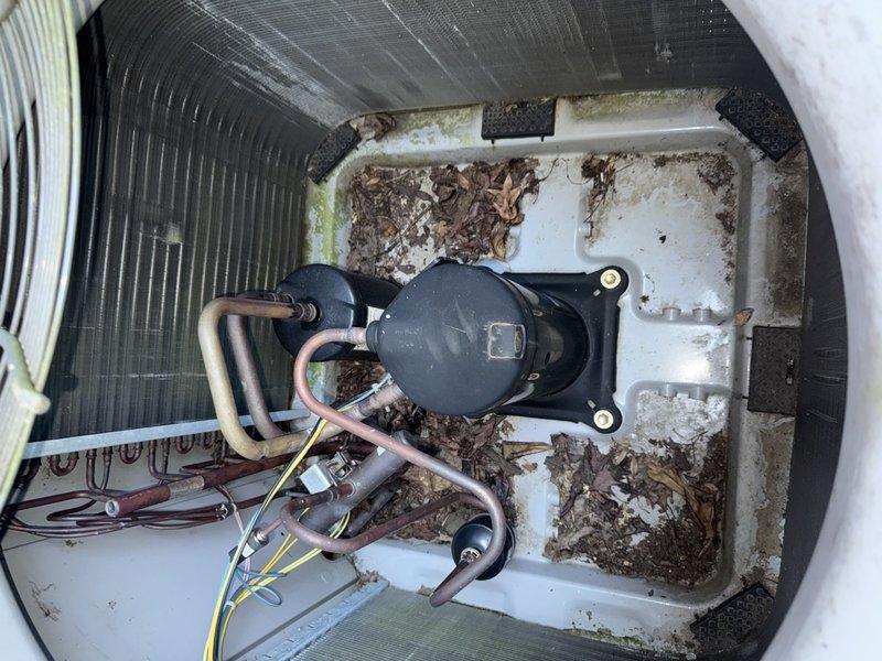 Completed Service Agreement Visit on residential HVAC system. Performed visual inspection of indoor evaporator unit and outdoor condensing unit. Indoor unit inspection revealed significant accumulation of organic debris, leaves, and dirt in the condensate drain pan surrounding the compressor assembly. Outdoor condenser unit inspection showed equipment in functional condition with all components intact and properly assembled. Documented system conditions with photographs for service records.