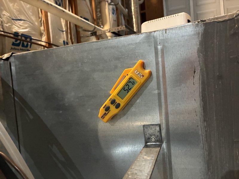 Responded to warranty service call for water leak investigation on HVAC system. Performed diagnostic temperature measurements on air handler unit and surrounding areas using digital thermometer, recording readings of 53°F at the duct/air handler and 72.8°F at the concrete surface near the unit. Inspected mechanical room conditions, noting exposed plumbing lines and system components. Documented findings with photographs for warranty claim processing and future reference.