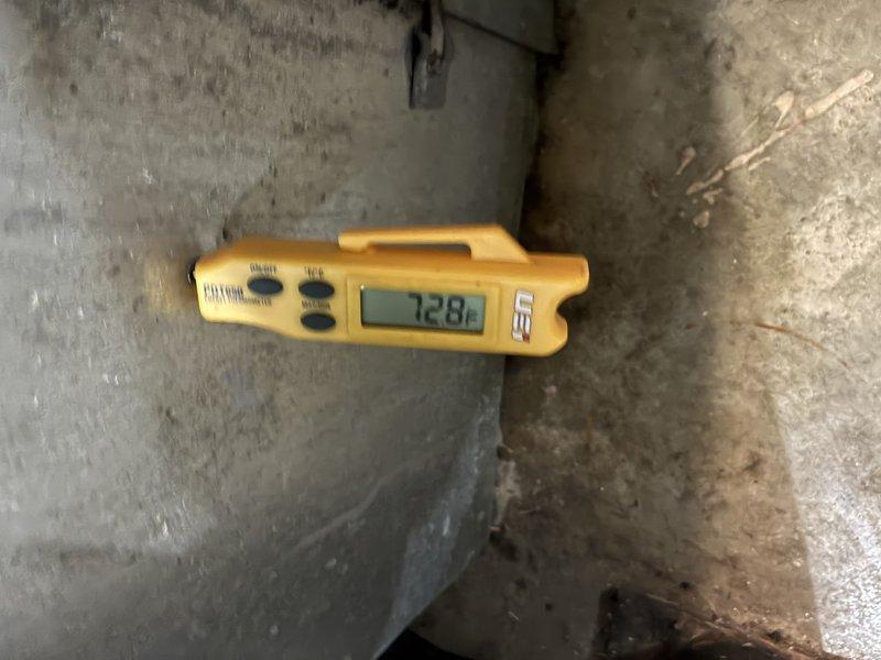 Responded to warranty service call for water leak investigation on HVAC system. Performed diagnostic temperature measurements on air handler unit and surrounding areas using digital thermometer, recording readings of 53°F at the duct/air handler and 72.8°F at the concrete surface near the unit. Inspected mechanical room conditions, noting exposed plumbing lines and system components. Documented findings with photographs for warranty claim processing and future reference.