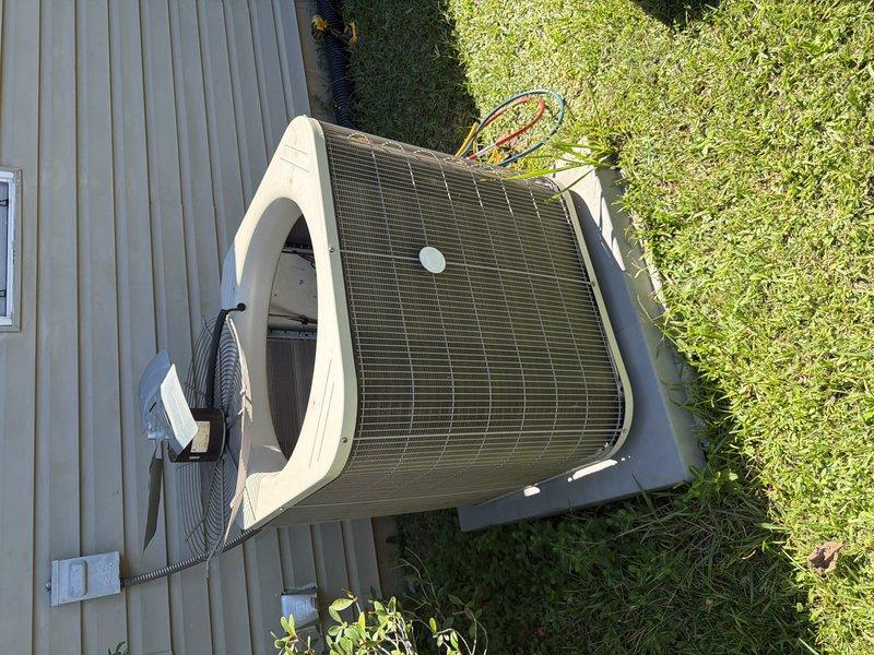 Completed Clean & Check service on residential HVAC system. Inspected outdoor condenser unit and found operational with proper airflow through coil fins. Examined condensate drain system on rooftop equipment, noting accumulated debris and staining in drain pan around pump assembly. Verified condensate pump operation and confirmed drainage lines were functioning. Checked electrical connections at disconnect box and unit wiring. System tested and left in proper working condition.