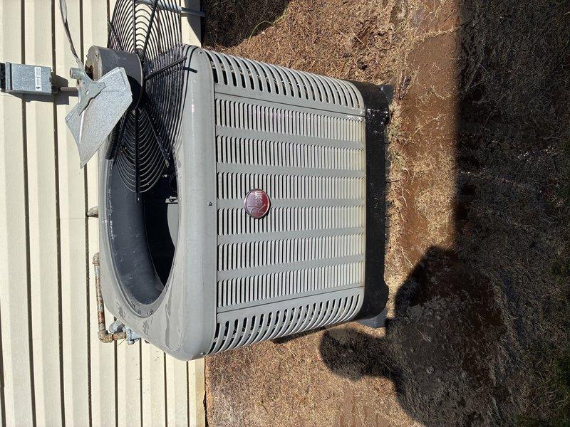 Completed routine Service Agreement Visit on residential air conditioning system. Performed visual inspection of outdoor condensing unit, documenting equipment condition through photographic records. Unit exterior shows normal operational wear with weathering consistent with outdoor exposure. Condenser positioned on concrete pad with proper clearances maintained from structure. Refrigerant lines and electrical connections inspected and found secure. Interior components including condenser fan motor, fan guard, and mounting hardware examined. Noted typical moisture staining and debris accumulation within unit housing consistent with normal outdoor operation. All major components operational with standard service wear patterns observed.