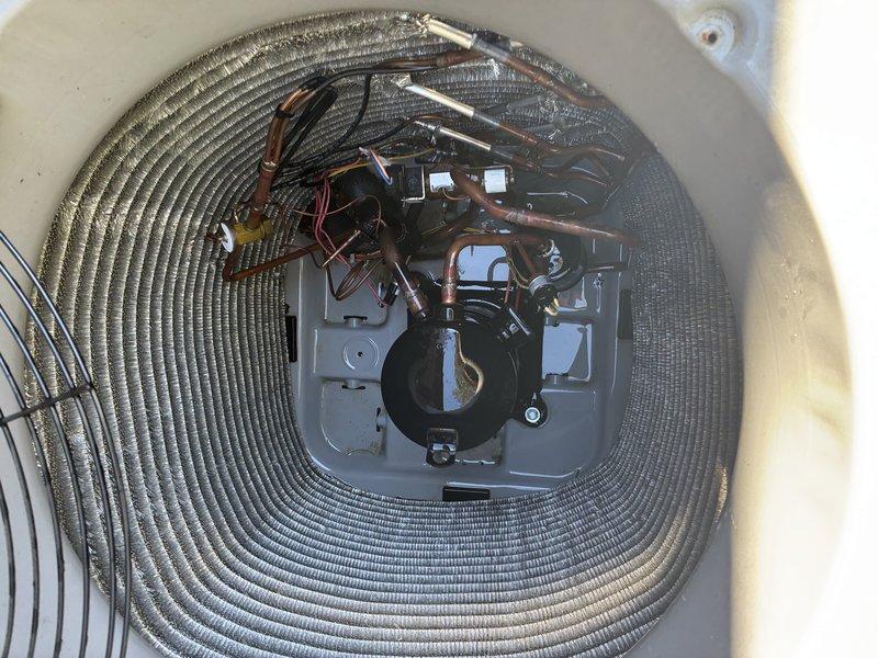Completed second service agreement visit for heating system maintenance on dual-unit HVAC system under warranty with UV light installation. Performed comprehensive inspection of cylindrical heating unit, verifying proper operation of spiral heating element, central motor assembly, and electrical connections. Inspected outdoor heat pump condenser unit, checking condenser coil fins, refrigerant lines, compressor components, and electrical control panel for proper operation and noting minor surface corrosion on motor housing consistent with normal outdoor exposure.