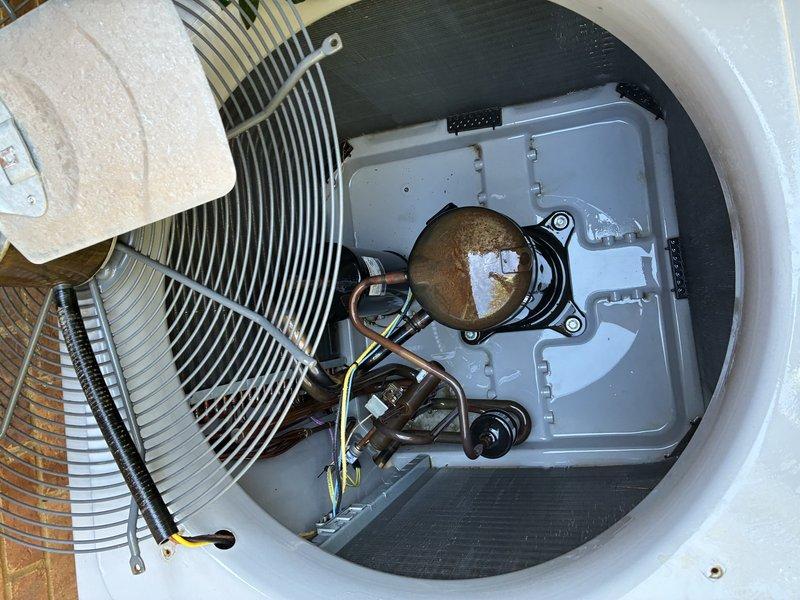 Completed second service agreement visit for heating system maintenance on dual-unit HVAC system under warranty with UV light installation. Performed comprehensive inspection of cylindrical heating unit, verifying proper operation of spiral heating element, central motor assembly, and electrical connections. Inspected outdoor heat pump condenser unit, checking condenser coil fins, refrigerant lines, compressor components, and electrical control panel for proper operation and noting minor surface corrosion on motor housing consistent with normal outdoor exposure.