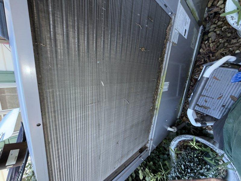# HVAC Clean & Check Service

Performed comprehensive clean and check service on residential HVAC system. Conducted thorough inspection of outdoor condenser unit, which exhibited significant debris accumulation between fins and general weathering from environmental exposure. Noted substantial dirt and organic material buildup along edges and within fin spaces of heat exchanger.

Inspected interior components and found evidence of contamination and debris accumulation requiring attention. System showed signs of extended outdoor exposure with dust, leaves, and organic matter present throughout equipment areas. Documented current condition of all accessible components through photographic records.

Completed standard clean and check procedures including visual inspection of all major system components. System is not covered under existing warranty or service agreement. No UV light system present on this installation. All findings and equipment conditions documented for service records.