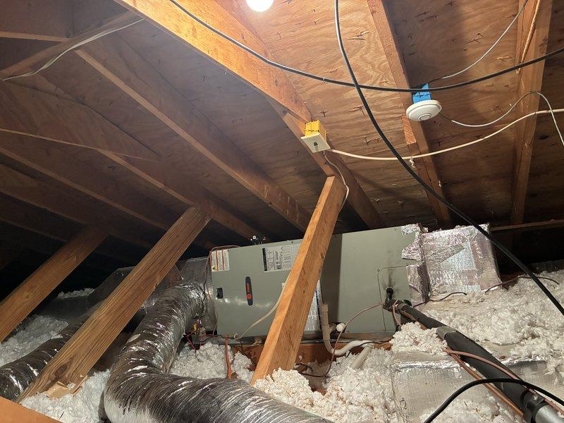 # HVAC System Clean and Check

Performed comprehensive clean and check service on residential HVAC system including air handling unit located in attic space and heating equipment in basement mechanical room. 

Inspected attic-mounted air handler and associated ductwork, verifying proper installation and condition of flexible duct connections. Examined electrical connections, wiring runs along rafters, and junction boxes for safety and code compliance. Assessed blown-in insulation coverage and verified adequate clearances around equipment.

In basement mechanical room, inspected furnace/heating unit with focus on burner assembly, heat exchanger, and ventilation components. Verified proper operation of safety controls and warning labels. Checked water heater and expansion tank for proper installation and function. Examined all visible plumbing connections including copper and PVC piping for leaks or deterioration.

Cleaned and inspected blower assembly, replaced air filter, and verified 