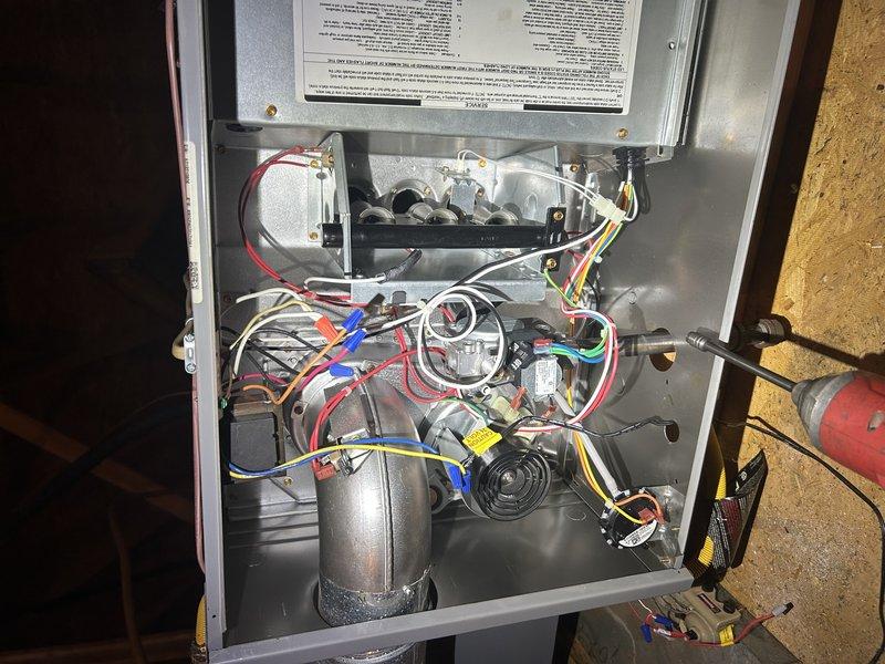 Performed a service agreement inspection on an attic-installed gas furnace with the front panel removed, visually checking the burner assembly, gas valve, inducer motor, pressure switch, flue piping, and control wiring. Verified the hot surface igniter gap and examined the wiring harness and connectors for damage. No rust, cracks, or other visible damage was found, and the unit appeared to be in good condition.