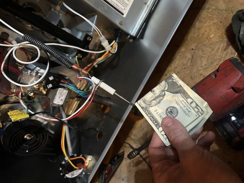 Performed a service agreement inspection on an attic-installed gas furnace with the front panel removed, visually checking the burner assembly, gas valve, inducer motor, pressure switch, flue piping, and control wiring. Verified the hot surface igniter gap and examined the wiring harness and connectors for damage. No rust, cracks, or other visible damage was found, and the unit appeared to be in good condition.