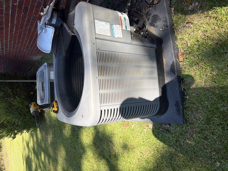 Responded to a service agreement visit on an outdoor condenser unit that is not our installed equipment. Opened the unit and inspected the interior, noting the compressor, wiring, and capacitor connections were intact and the coil fins were in good condition, with standing water and moisture present in the base pan. No UV light was present or serviced on this system.