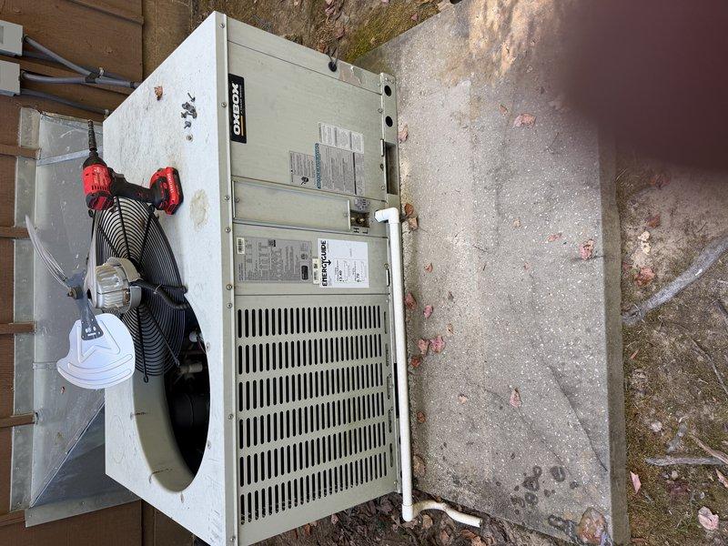 Performed a scheduled maintenance visit on the outdoor condenser unit, removing the top panel and fan assembly to access the interior. Inspected the condenser fan motor, compressor, wiring, and refrigerant lines, and found heavy accumulation of dirt, leaves, and debris inside the cabinet that was restricting airflow and reducing efficiency. Cleared the debris from the unit interior and surrounding pad, and prepared the unit for coil cleaning and reassembly.