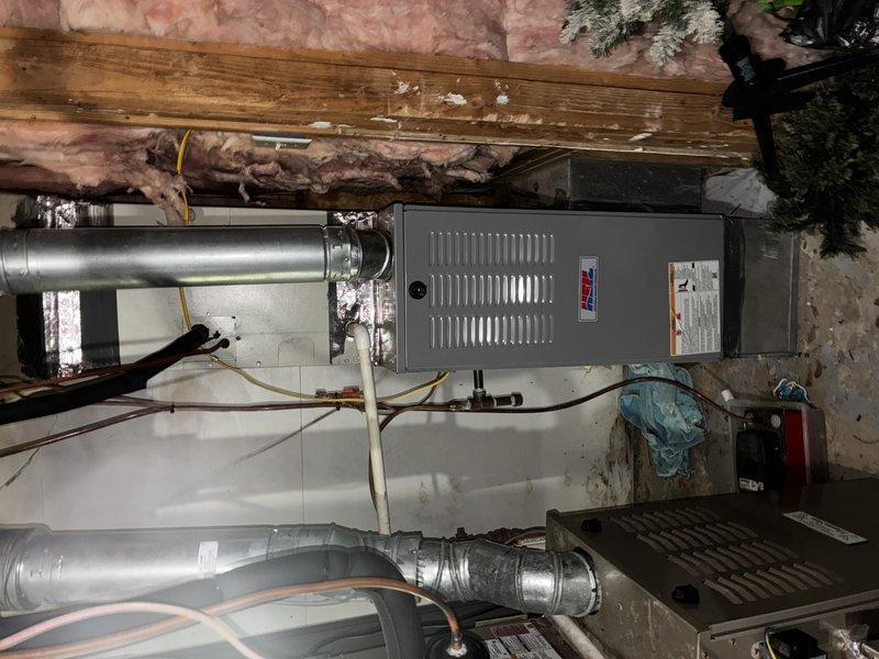 Performed first service agreement visit on two heating systems, inspecting the gas furnace, air handler, ducting, and associated components. Verified the UV light is installed on the heating system, checked the condensate drain, and inspected the refrigerant line set and electrical connections. Noted torn foam insulation and a ragged panel opening at the refrigerant line entry, along with loose, shredded fiberglass insulation in the joist bay, and recommend repair to maintain system efficiency.