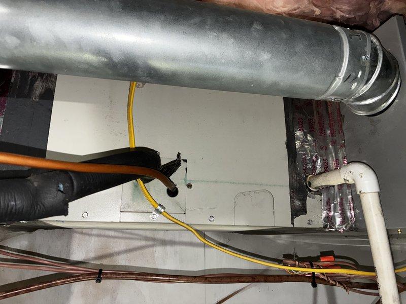 Performed first service agreement visit on two heating systems, inspecting the gas furnace, air handler, ducting, and associated components. Verified the UV light is installed on the heating system, checked the condensate drain, and inspected the refrigerant line set and electrical connections. Noted torn foam insulation and a ragged panel opening at the refrigerant line entry, along with loose, shredded fiberglass insulation in the joist bay, and recommend repair to maintain system efficiency.