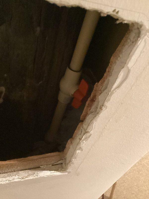 Responded to service call for Matthew Wilson regarding frozen water line. Inspected interior access point revealing PVC plumbing with shut-off valve, and identified outdoor faucet with significant ice formation at base. Performed thawing procedure on frozen pipe section and verified proper water flow restoration.