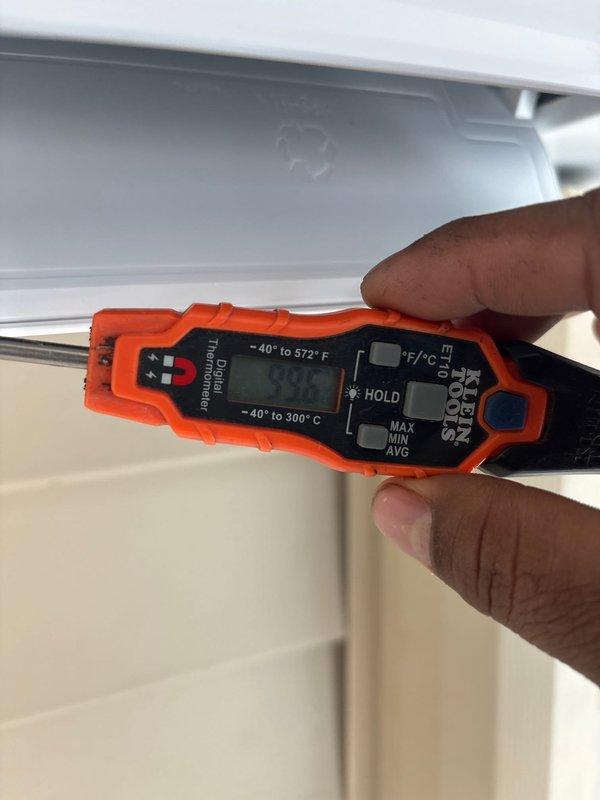 Completed installation of Mitsubishi Ductless Series mini-split system, including a 12,000 BTU 25 SEER MUZ-GX12NL outdoor heat pump unit and MSZ-GX12NL wall-mounted indoor air handling unit with remote thermostat. Relocated outdoor unit from under steps to parallel position outside steps, reused existing lineset and slim duct for indoor unit, and performed temperature verification to ensure proper system operation.