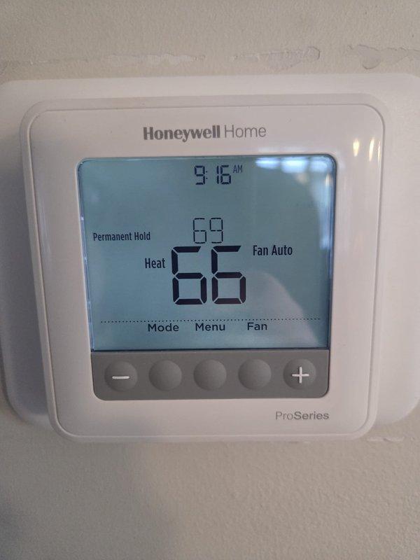 Performed heating maintenance on dual systems. Verified proper operation of Honeywell ProSeries thermostat (current temp 69°F, set point 66°F) and provided client with operational instructions as requested. Inspected ductwork insulation and filter compartment, with temperature readings recorded at measurement points.