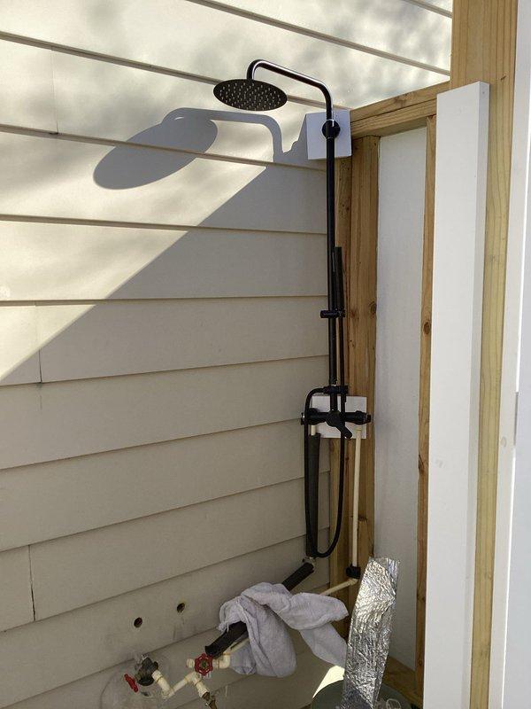 Responded to service request for outdoor shower plumbing issues. Inspected installation from May that was improperly piped, causing freeze damage. Installed insulation on exposed water lines to prevent further freeze damage, while noting customer's future plans for complete reinstallation with proper crawl space shutoff valve.