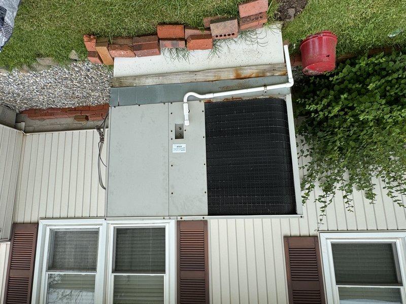 Conducted estimate for replacement of downstairs package unit per owner's request. Existing unit is operational but has worn nameplate making identification difficult. Inspected current installation which is mounted on exterior wall with PVC condensate line. Evaluated existing Honeywell thermostat (currently reading 67°F) for compatibility with potential replacement system.