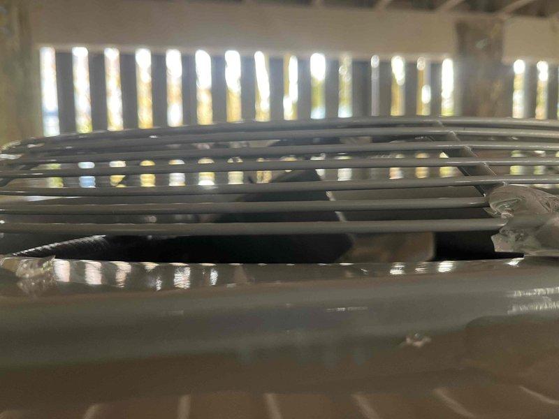 Responded to no heat complaint for one of four HVAC systems in residence. Inspection of the outdoor unit serving master bedroom revealed missing wiring panel and dislodged fan blade. Observed ice formation on condenser fan grill indicating system malfunction. Repairs needed to restore proper operation.