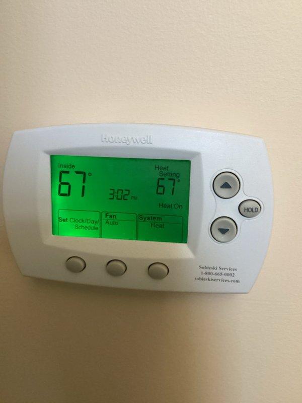Performed tune-up inspection on one system per customer request. Checked thermostat functionality - confirmed Honeywell digital thermostat operating correctly with proper temperature display (67°F) and heat mode functioning. System heat check completed with all parameters within normal operating ranges.