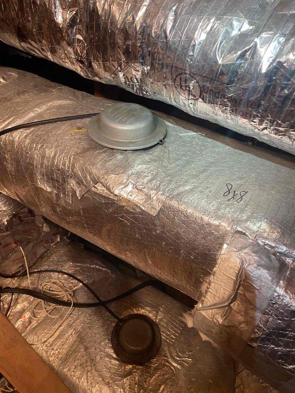 Responded to no heat complaint during extreme cold conditions. Upon inspection, found heat pump system severely iced over. Activated emergency heat mode to allow defrost cycle to complete while inspecting ductwork insulation in attic space. Verified proper system operation after defrost cycle completed and confirmed all connections were secure.