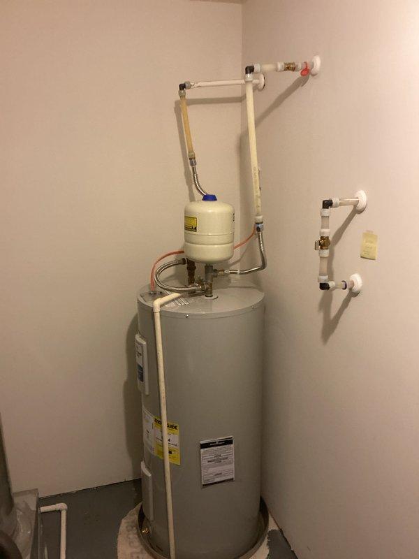 Successfully completed removal and installation of a Bradford White 50-gallon electric medium water heater with expansion tank in utility area. Old unit was properly disposed of and new system was connected to existing plumbing with all necessary valves and fittings, ensuring proper function and compliance with current codes.